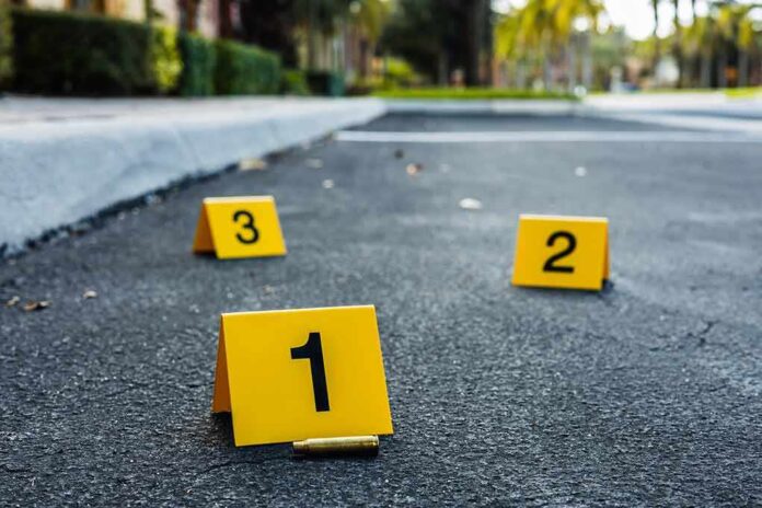 shutterstock_2182405839 featured image Crime scene markers on asphalt with bullet casing