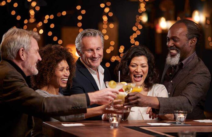 1038716299 featured image People laughing while clinking glasses at a bar