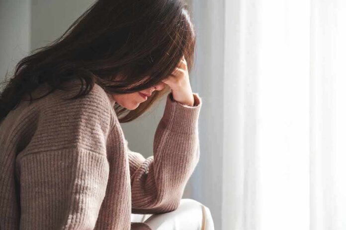 2392242465 featured image Person with head downlooking distressed or contemplative