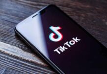 Phone screen showing TikTok logo and app