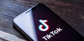 Phone screen showing TikTok logo and app