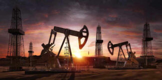 Oil rigs operating at sunset in a desert landscape