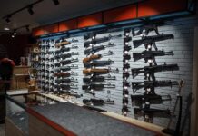Wall display of various rifles in a gun store