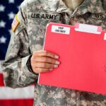 Soldier holding red top secret file folder