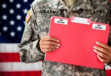 Soldier holding red top secret file folder