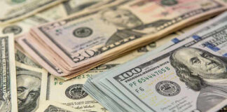 Stacks of various U.S. dollar bills