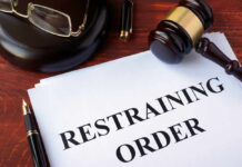 Gavel glasses pen restraining order document on table
