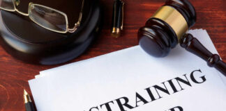 Gavel glasses pen restraining order document on table