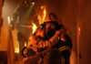 Firefighter rescues child from burning building.