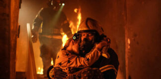 Firefighter rescues child from burning building.
