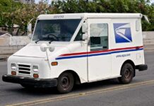 White USPS delivery truck parked on a street