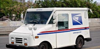 White USPS delivery truck parked on a street