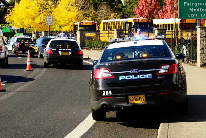 Police cars and school buses on a road