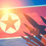 North Korea’s Uranium Bombshell Shocks World Leaders North Korean flag with missile silhouettes