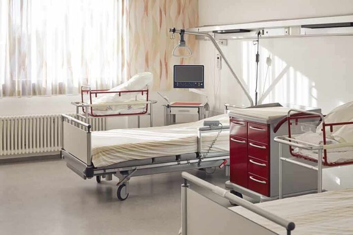 A hospital room featuring empty patient beds and medical equipment