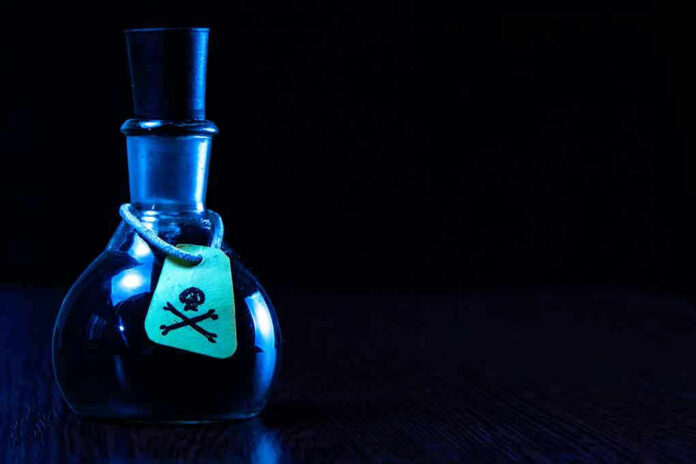Dark bottle with skull and crossbones label on table