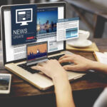 Taliban CRUSHES 40 Million Into Digital Darkness Person reading news websites on a laptop.