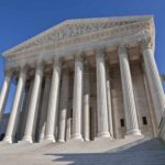 Supreme Court CRUSHES State Anti-Gun Schemes The Supreme Court building featuring grand columns and statues under a clear blue sky