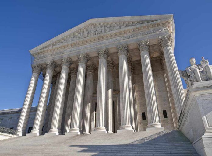 shutterstock_56445421.jpg The Supreme Court building featuring grand columns and statues under a clear blue sky