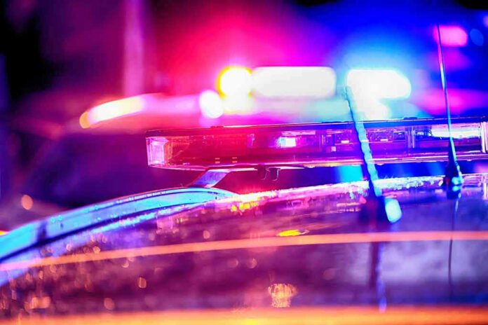 Close-up of police car lights flashing at night.