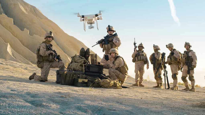 Soldiers operating a drone in a desert environment
