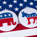 Republican elephant and Democrat donkey on American flag