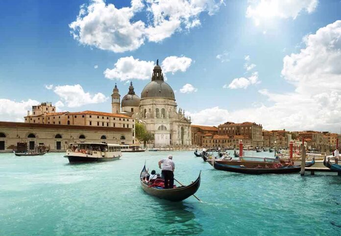 Gondolas on a canal in Venice with historic buildings in the background