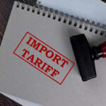 Trump’s NEW 25% Tariff Bombshell—See WHO’S Affected Notebook with Import Tariff stamp and rubber stamper.