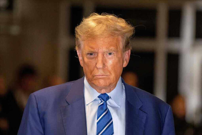 Man in blue suit and striped tie, serious expression.