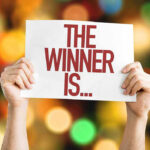 Explosive WIN – Nurse’s Reinstatement VICTORY Hands holding a sign reading The Winner Is