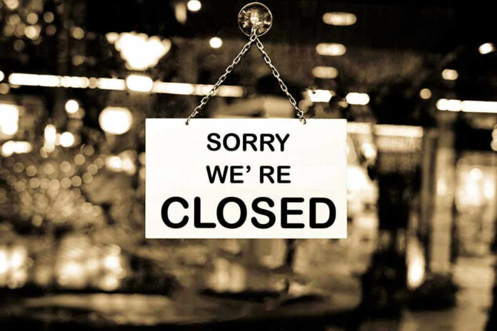 Closed sign hanging in a shop window.