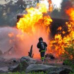 Trump’s Order OVERTURNS Wildfire Recovery Firefighter battling a large fire with water spray