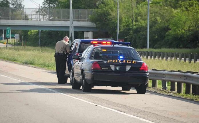Police officer conducting a traffic stop on a highway
