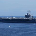 SUPERCARRIERS Rushed To Middle East A large aircraft carrier sailing in the ocean