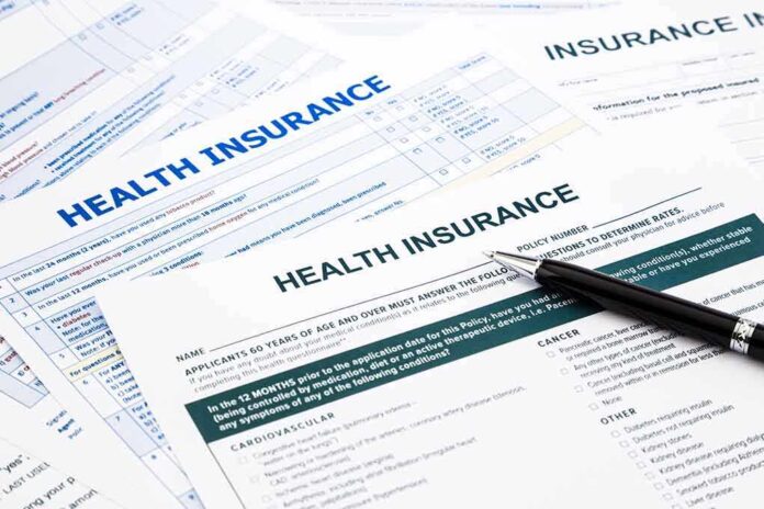 Close-up of health insurance application forms with a pen
