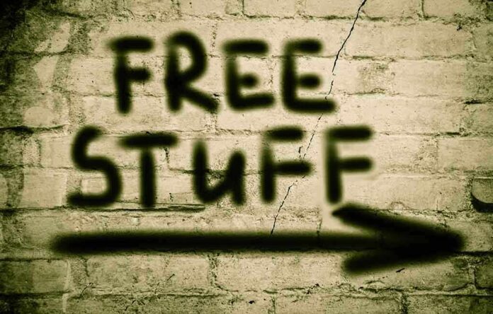 Graffiti on a brick wall stating FREE STUFF with an arrow