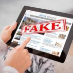 FAKE DATE Fallout — Alarming Security Exposed Person holding a tablet displaying a news website with a 'FAKE' stamp