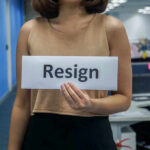 EPSTEIN Files Detonate Goldman Power Exit Person holding a sign that says resign