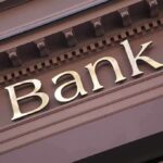 Close-up of a bank sign with gold lettering