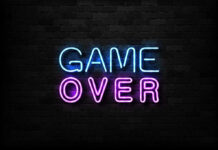 Game Over neon sign on brick wall.