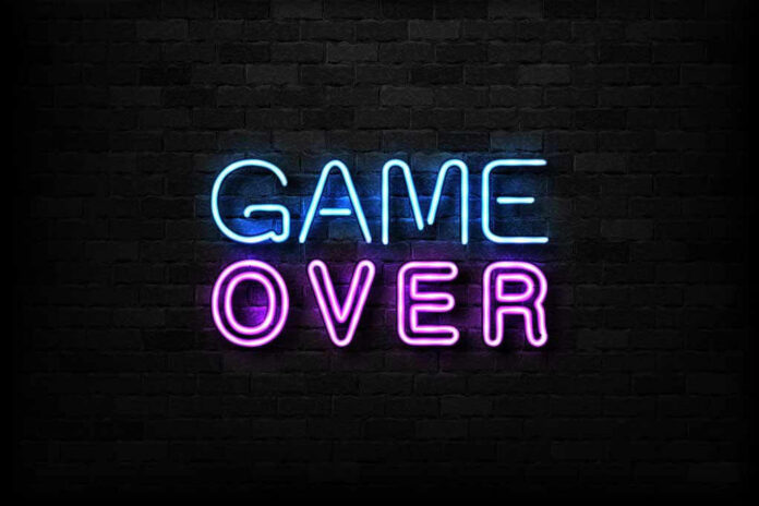 Game Over neon sign on brick wall.