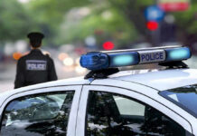 Police car and officer on a city street.