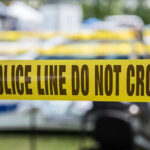 Pregnant Woman SEALED In Tote Yellow police line tape with Do Not Cross.