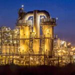 BREAKING: Trump Crushes 50-Year Refinery Freeze An industrial facility with illuminated structures at night