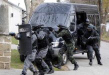 SWAT team members in tactical gear responding to a situation