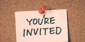 A note pinned to a corkboard that says 'YOU'RE INVITED'