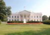 The White House surrounded by manicured gardens and a fountain