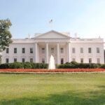 The White House surrounded by manicured gardens and a fountain