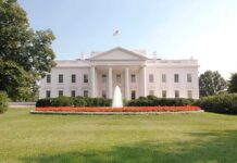 The White House surrounded by manicured gardens and a fountain