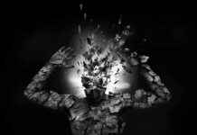 A fragmented human figure with an exploding head in a black and white setting